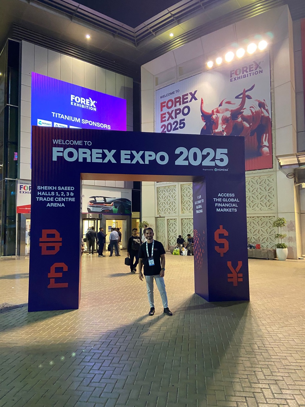 Gabriele Nigro at the entrance to The Forex Expo 2025 in Dubai, standing under the event archway.